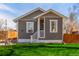 Charming single-story home with gray siding, front porch, and lush green lawn at 1350 Valentia St, Denver, CO 80220