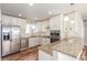 Bright kitchen featuring stainless steel appliances, granite countertops, and white cabinets at 1350 Valentia St, Denver, CO 80220