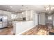 Modern kitchen with stainless steel appliances, white cabinetry, and granite countertops at 1350 Valentia St, Denver, CO 80220