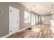 Well-lit living area featuring hardwood floors, large window, and open layout to the kitchen at 1350 Valentia St, Denver, CO 80220