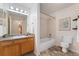 Well-lit bathroom features single vanity, shower-tub combo, and neutral tones at 16848 E Gunnison Dr # 9E, Aurora, CO 80017