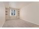 Bright bedroom with neutral walls, carpet floors, and built-in shelving at 16848 E Gunnison Dr # 9E, Aurora, CO 80017