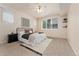 Cozy carpeted bedroom features a ceiling fan and bright window views at 16848 E Gunnison Dr # 9E, Aurora, CO 80017