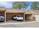 An open carport with a parked white SUV provides protected parking from the elements at 16848 E Gunnison Dr # 9E, Aurora, CO 80017