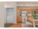 Bright eat-in kitchen features oak cabinetry, white appliances, and in-unit laundry at 16848 E Gunnison Dr # 9E, Aurora, CO 80017