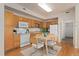 Well-lit kitchen with wooden cabinets, essential appliances, and a cozy dining area for casual meals at 16848 E Gunnison Dr # 9E, Aurora, CO 80017