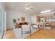 Bright living room with access to the balcony, hardwood floors, and an open layout to the kitchen and dining area at 16848 E Gunnison Dr # 9E, Aurora, CO 80017