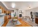Open-concept living space with hardwood floors, a cozy fireplace, and seamless transition to the dining area and kitchen at 16848 E Gunnison Dr # 9E, Aurora, CO 80017