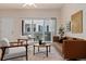 Inviting living room featuring stylish furniture, neutral tones, and access to outdoor living space at 16848 E Gunnison Dr # 9E, Aurora, CO 80017