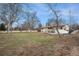 Expansive backyard with mature trees, lawn, garden space and outdoor entertaining area at 5145 S Clarkson St, Greenwood Village, CO 80121