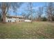 Expansive backyard with mature trees, lawn, garden space, firepit and outdoor entertaining area at 5145 S Clarkson St, Greenwood Village, CO 80121