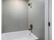 Clean bathroom featuring a modern shower head, bronze fixtures, and white tub at 5145 S Clarkson St, Greenwood Village, CO 80121
