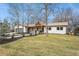 Inviting single-story home with a well-manicured lawn, pathway, and natural wood porch in a charming neighborhood at 5145 S Clarkson St, Greenwood Village, CO 80121