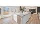 Open kitchen with an island featuring a marble countertop, stainless steel appliances and views to backyard at 5145 S Clarkson St, Greenwood Village, CO 80121