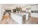 Open kitchen with a large island featuring a marble countertop, stainless steel appliances and stylish backsplash at 5145 S Clarkson St, Greenwood Village, CO 80121