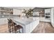 Bright kitchen features an oversized island with marble countertop, modern appliances, and stylish shelving at 5145 S Clarkson St, Greenwood Village, CO 80121