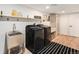A modern laundry room with ample storage, folding counter, dog wash station and new machines at 5145 S Clarkson St, Greenwood Village, CO 80121