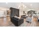 Open-concept living room with modern fireplace, stylish sofas, and a view of the updated kitchen at 5145 S Clarkson St, Greenwood Village, CO 80121