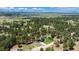 Property lines shown from an aerial view outlining the home, garage, and wooded acreage at 33589 Robin Ct, Elizabeth, CO 80107