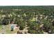 Aerial view of neighborhood with a green roofed outbuilding, surrounded by dense forest at 33589 Robin Ct, Elizabeth, CO 80107