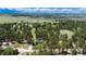 Scenic aerial view of the property surrounded by lush green trees, with a clear view of the house and grounds at 33589 Robin Ct, Elizabeth, CO 80107