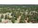 Aerial view of a home and outbuilding with green roofs, in a densely wooded area and property boundary at 33589 Robin Ct, Elizabeth, CO 80107