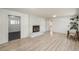 Spacious basement area with wood-look flooring, brick fireplace, and open doorway for easy access to other rooms at 33589 Robin Ct, Elizabeth, CO 80107