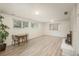 Well-lit basement area showcasing modern wood-look flooring, perfect for a dining area or flexible living space at 33589 Robin Ct, Elizabeth, CO 80107