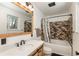 A well-lit bathroom with a bathtub, modern vanity, and shower at 33589 Robin Ct, Elizabeth, CO 80107