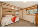 Relax in this cozy carpeted bedroom with natural wood trim and mountain decor at 33589 Robin Ct, Elizabeth, CO 80107