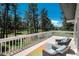 Inviting deck featuring comfortable seating and scenic views of the lush green landscape and mature trees at 33589 Robin Ct, Elizabeth, CO 80107