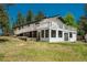 Back of the home featuring a large deck and patio perfect for outdoor entertaining and enjoying the serene surroundings at 33589 Robin Ct, Elizabeth, CO 80107
