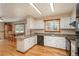 Eat-in kitchen boasts white cabinets, black appliances, ample counter space, and access to the dining area at 33589 Robin Ct, Elizabeth, CO 80107