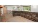 Bright living room featuring a large sectional couch, an upstairs landing, and plenty of windows for natural light at 33589 Robin Ct, Elizabeth, CO 80107