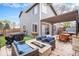 Inviting backyard with a cozy fire pit lounge area, a modern spa, and lush green landscaping at 1271 Braewood Ave, Highlands Ranch, CO 80129