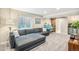 Cozy basement with large gray sectional sofa, wood sliding door, and relaxing living space at 1271 Braewood Ave, Highlands Ranch, CO 80129