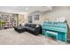 Relaxing basement featuring a sectional sofa, custom shelves, and cozy living space at 1271 Braewood Ave, Highlands Ranch, CO 80129