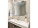 Half bathroom featuring a modern mirror and vessel sink with stylish brushed nickel fixtures at 1271 Braewood Ave, Highlands Ranch, CO 80129