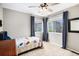 Bright bedroom with a ceiling fan, carpet flooring, and large windows that brings in plenty of natural light at 1271 Braewood Ave, Highlands Ranch, CO 80129