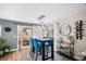 Dining room with modern lighting, bar, and access to outdoor space for relaxation and entertainment at 1271 Braewood Ave, Highlands Ranch, CO 80129