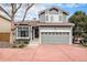 Charming two-story home with a red driveway, inviting curb appeal, and a well-manicured lawn at 1271 Braewood Ave, Highlands Ranch, CO 80129