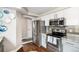 Modern kitchen featuring stainless steel appliances, including a refrigerator and oven, with granite countertops at 1271 Braewood Ave, Highlands Ranch, CO 80129