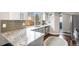 Bright kitchen featuring modern appliances, granite countertops, and plenty of natural light at 1271 Braewood Ave, Highlands Ranch, CO 80129