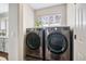 Modern laundry room with front-load washer and dryer at 1271 Braewood Ave, Highlands Ranch, CO 80129