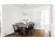 Modern farmhouse dining room with wood table and black chairs at 5095 Umatilla St, Denver, CO 80221