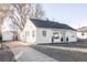 Newly renovated home with a gravel driveway and a detached garage at 5095 Umatilla St, Denver, CO 80221