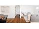 Bright hallway with hardwood floors and access to living and dining areas at 5095 Umatilla St, Denver, CO 80221