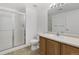 Bathroom includes toilet, vanity with sink, mirror, and tiled shower with glass doors at 3261 S Waco Ct # K, Aurora, CO 80013