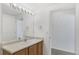 Well-lit bathroom features a wide mirror, ample counter space, and pristine white walls at 3261 S Waco Ct # K, Aurora, CO 80013