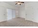 Spacious bedroom with carpet, ceiling fan, and a sliding glass door at 3261 S Waco Ct # K, Aurora, CO 80013